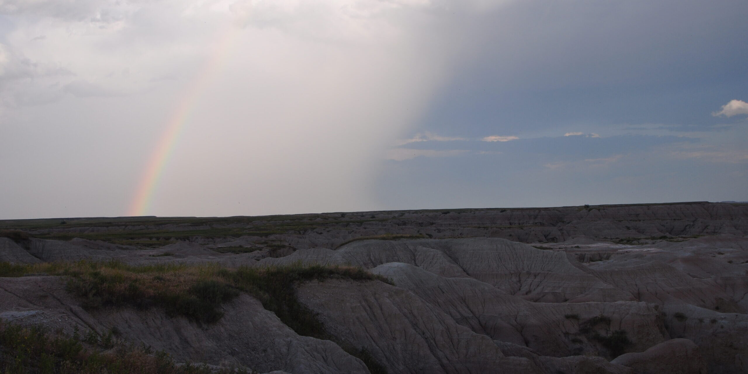 rainbow over desert hills